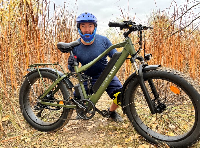 Bee Cool Adventurer Fat Tire Ebike with Full Suspension in Army Green in the bushes